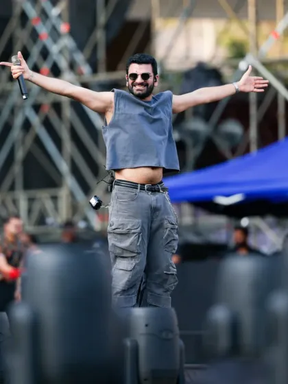 The lead singer of The Yellow Diary, our opening act, greets the massive stadium crowd. We believe in giving a grand stage to emerging artists.