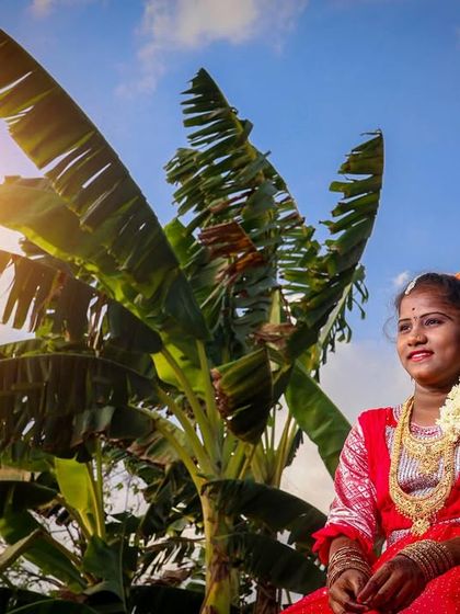 A beautiful environmental portrait taken during an outdoor puberty ceremony shoot. The banana tree and the warm sun flare add a natural, rustic feel that is very authentic to our culture.