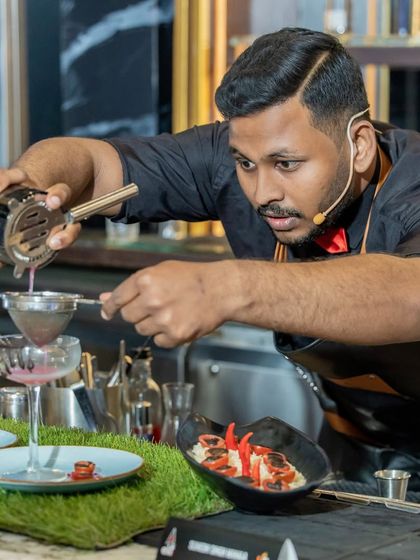 Swaroop in action during the competition, showcasing his exceptional skill and creativity in crafting a unique cocktail.