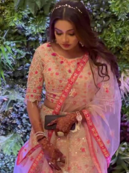 Another candid shot of the light pink floral rental lehenga, showing the pretty border on the dupatta.