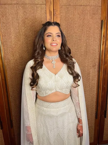 Simran looking absolutely angelic and happy in her all-white ensemble.