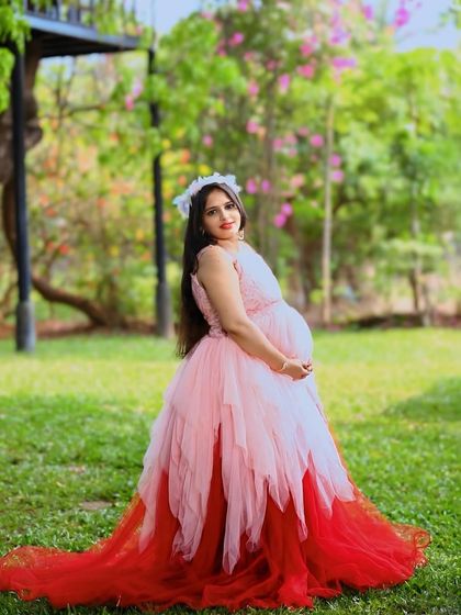 This unique asymmetric gown features layers of peach and red net, creating a beautiful ombre effect. It's a playful and colorful option for an outdoor shoot.