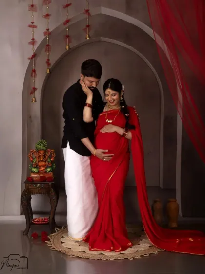 A beautiful couple's portrait in traditional South Indian attire. His hand on her bump is a gesture of love and protection.