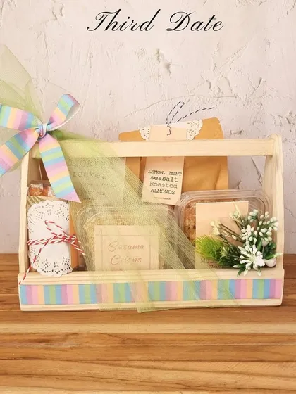 Third date? It's hamper time! This curated hamper with a rainbow ribbon is filled with their favourite snacks to show you've been paying attention.