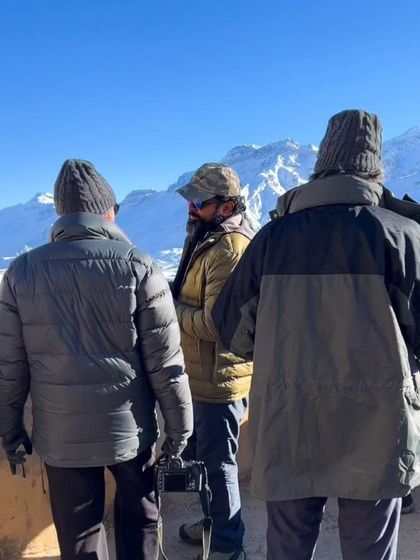 A behind-the-scenes shot of me and my friends bundled up against the cold, camera in hand.