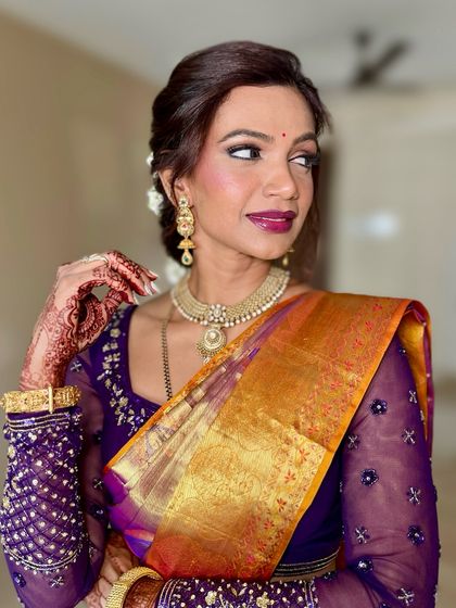 This candid shot captures a moment of reflection. The soft glam makeup, with its focus on skin and a defined lip, looks beautiful from every angle.