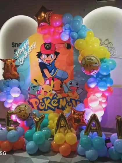 A vibrant Pokémon-themed birthday party for Ryan. This decoration includes a backdrop with Ash and his Pokémon, character foil balloons, and a colorful balloon circle, perfect for a young fan.