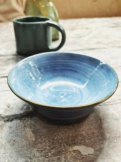 After her beginner's course, this student rejoined for the advanced level. She created beautiful wheel-thrown mugs and bowls, and also explored sculptural hand-building, creating this unique candlestick holder.