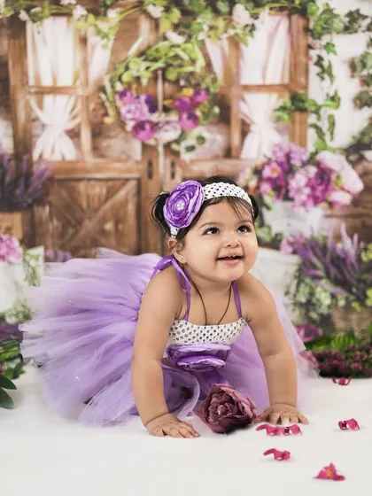 Crawling through a field of flowers. Our studio setups provide a safe and beautiful environment for babies to explore during their session.