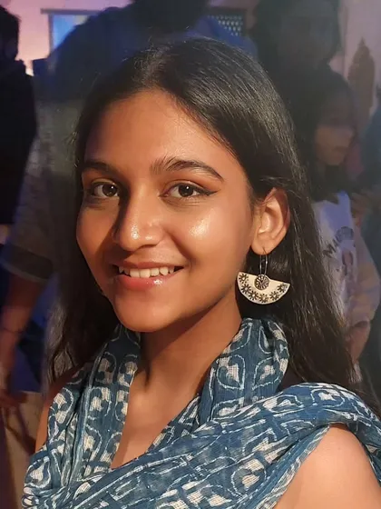 A smiling customer wearing a pair of my semi-circle patterned earrings at the Bhopal Potter's Market. These are lightweight and perfect for everyday wear.