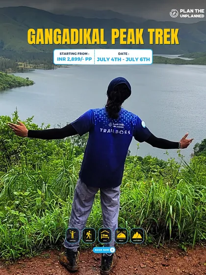 A trekker enjoys the view of a lake from the Gangadikal Peak trail.