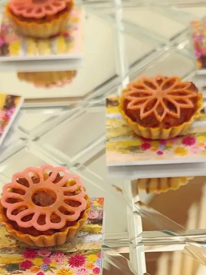 Intricate lotus-topped tarts served on mirrored trays for the Rahul Mishra event. The floral motif was drawn directly from the designer's embroidery work, creating a direct link between the food and fashion.