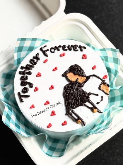 A romantic bento cake with a hand-piped drawing of a couple and the message "Together Forever."