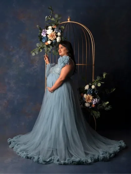 For the mama who wants to feel like a queen. In my studio, we create these elegant, glamorous portraits with flowing gowns and artistic setups like this floral cage, celebrating your strength and beauty in this powerful chapter.