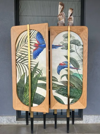 We believe a bar cabinet should be a conversation starter. This custom piece features hand-painted macaw art by Sachin Samson, framed in solid wood with elegant brass accents. It is designed not just to store spirits, but to elevate the entire ritual of hosting.