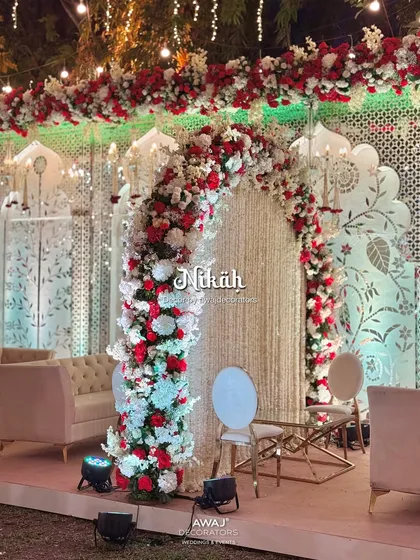 A beautiful Nikah stage setup, with a floral arch of red and white roses creating a sacred space for the ceremony.