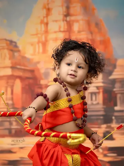 A close-up shot against a temple backdrop, this portrait of a young Lord Ram is full of character. The lighting highlights the child's curly hair and determined expression.