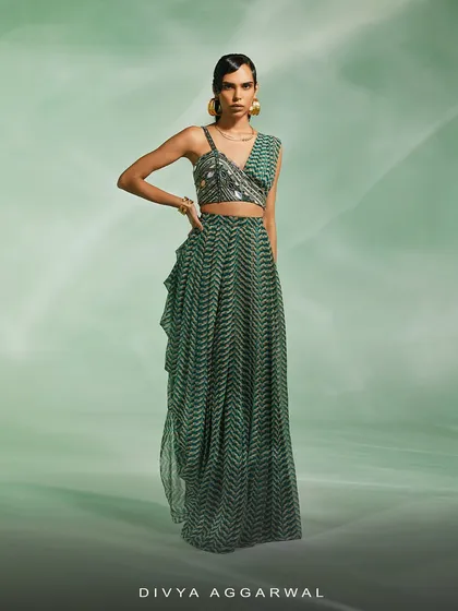 A modern take on the green print, this co-ord set features a drape skirt and an embellished asymmetrical blouse.