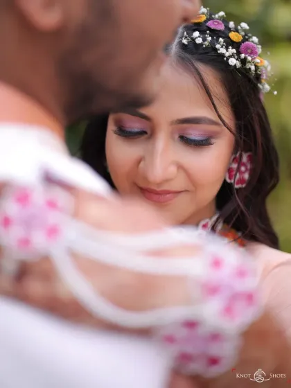A romantic close-up with her partner. The soft, colorful eye makeup is visible here, adding a touch of artistry to her Haldi look.