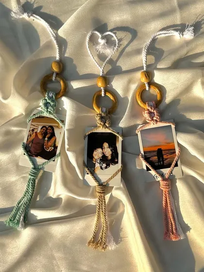 Turn your favorite memories into a beautiful keepsake with our macrame polaroid holders. We hand-knot each holder with your choice of colored cord and can even print your photo for you. It's a perfect, personalized gift for friends, partners, or yourself.