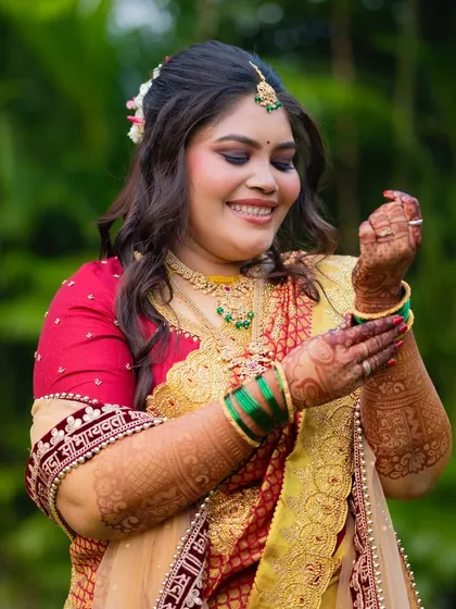 A candid moment of the bride adjusting her bangles. The makeup is flawless, even in these unposed shots.