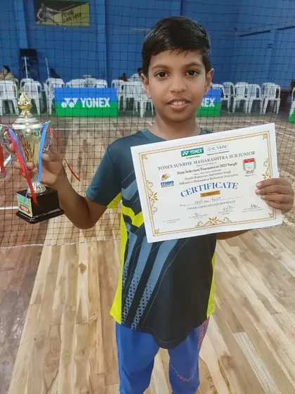 Holding up the trophy and certificate, Pratham shows the rewards of his dedication. We are proud of his achievement as a runner-up at the state level.