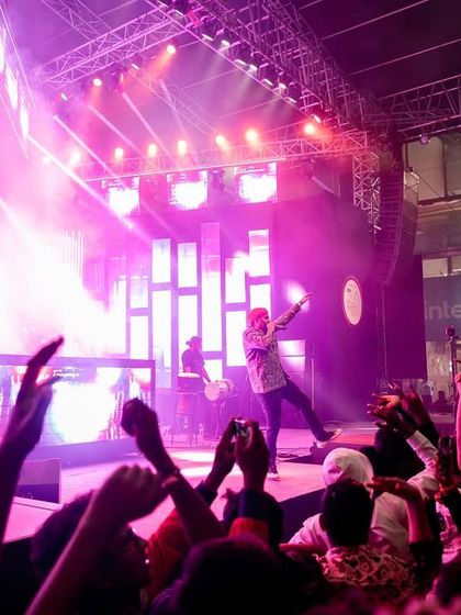 The crowd with their hands up, capturing the energy of our DJ and percussion set.