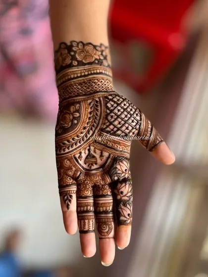 A close-up of a single hand, showing a mix of jaali, floral, and paisley patterns. This is a great option for a party or festival.