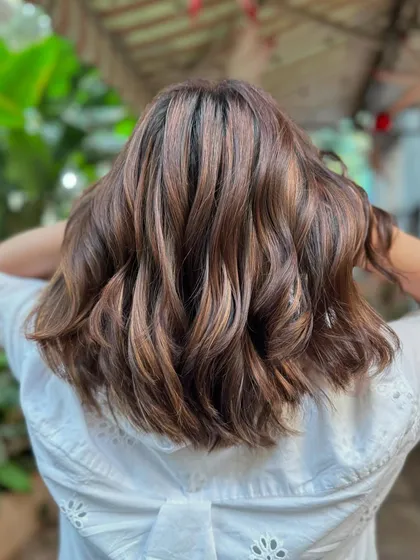 Another angle of the 'Brown Sugar' bob, with the light catching the warm, sweet tones. It's a super stylish and low-maintenance look.