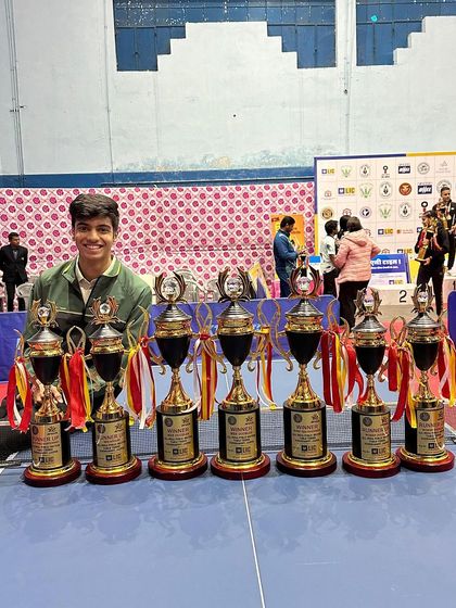 Aakash K J with his impressive collection of trophies, celebrating his selection to represent India in international WTT tournaments.