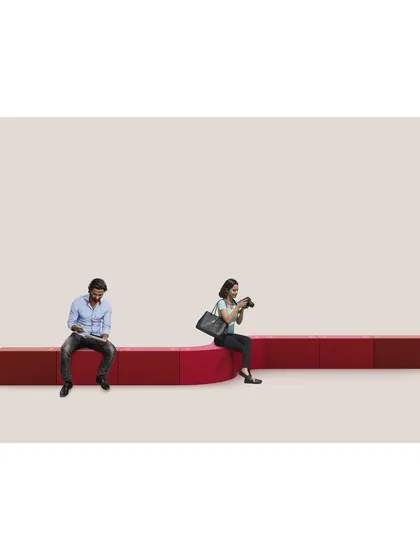 The LOKI modular bench demonstrates our belief in playful, adaptable design. Here, a series of straight and curved modules are combined to create a unique seating arrangement in a public space, showing how furniture can be both functional and interactive.