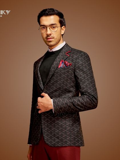 This geometric patterned blazer, paired with deep red trousers, is designed for the man who isn't afraid to make a style statement. It's a look that is both sophisticated and bold.