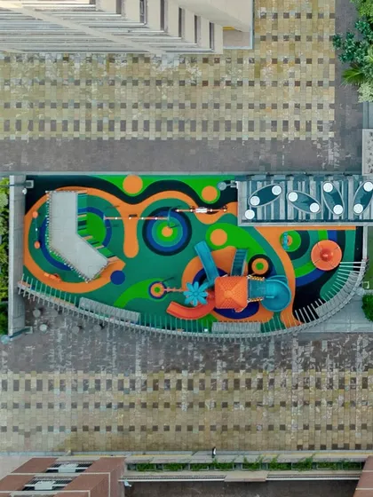 We believe community spaces should inspire joy. This aerial shot showcases the vibrant, custom-designed playground at PIXELSCAPES, where colorful, safe flooring and imaginative equipment create a hub of activity and fun for the community's youngest residents.
