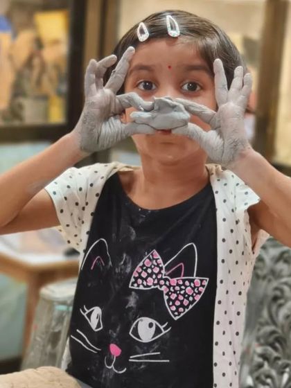 Creativity knows no age. This young artist is having a blast getting her hands messy and learning the fundamentals of working with clay in our kids' pottery class.