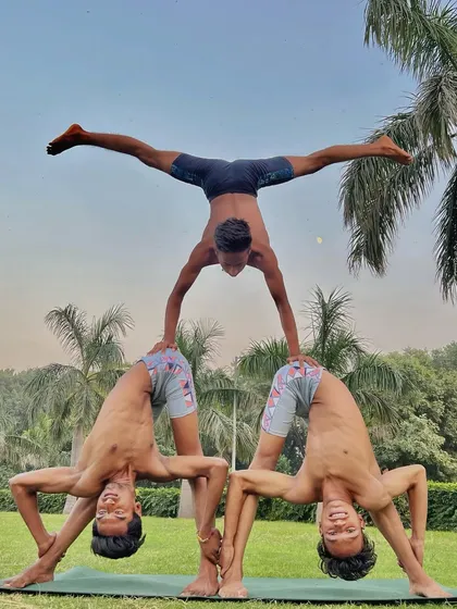 Another angle of our three-person acro yoga pyramid, showing the split variation at the top. This is what dedicated group practice looks like.