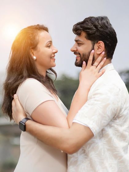 A happy, natural portrait of a couple sharing a smile. This close-up captures their genuine joy and connection.