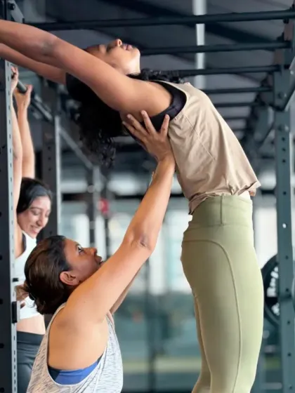 Using the support of a rack and a partner, this student is exploring a deep backbend. My advanced classes often use props and partner work to help students safely access more challenging postures.