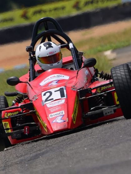 A dynamic shot of the Formula LGB car leaning into a turn, highlighting the vehicle's suspension and the driver's control.