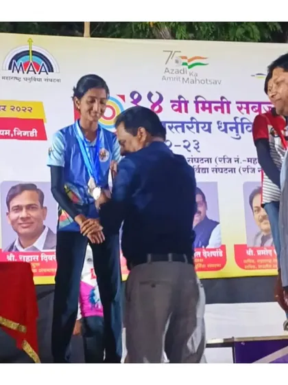 An official presenting a medal to our student at the state level competition. These formal ceremonies are an important part of the competitive experience.