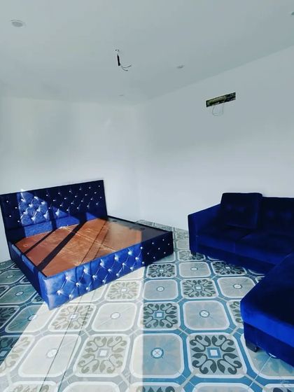 A view of a fully furnished prefab room, showing how it can comfortably accommodate both a bed and a seating area, creating a complete studio apartment on your terrace.