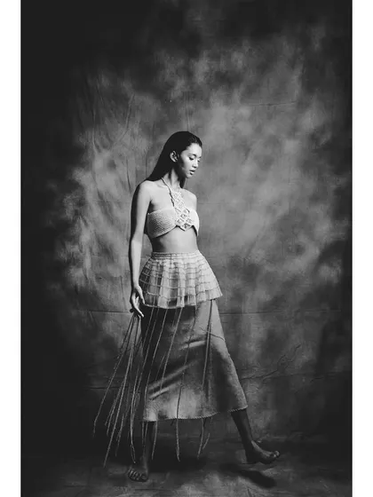 A black and white version from the 'Sandcastles' shoot. Stripping away the color emphasizes the form, texture, and the graceful lines of the model's pose.