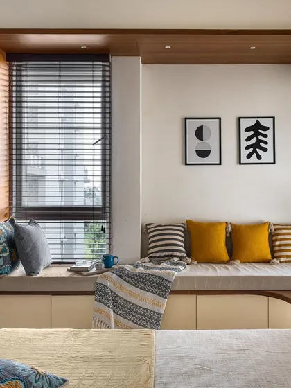 This cozy bay window seat, framed by our signature wooden ledges, offers a perfect spot for reading or enjoying a cup of tea. The design includes integrated storage, making it a practical and charming addition to the bedroom.