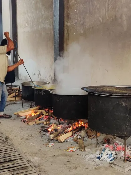 This is where the magic begins. We cook our biryani and curries the traditional way, in large 'degs' over a wood fire. This slow-cooking process is key to achieving the authentic, smoky flavor that our customers love.