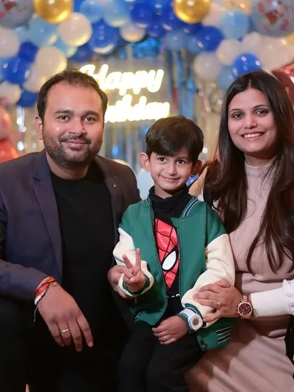A Peppa Pig-themed party is always a hit with the little ones. Here, the birthday boy and his family pose in front of a custom balloon setup.