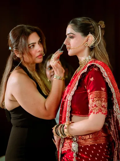 This is me in my element, making sure every detail is perfect. Placing the traditional nath is a final, crucial touch for a Maharashtrian bride, completing the sacred 'shringaar' that we thoughtfully create together.
