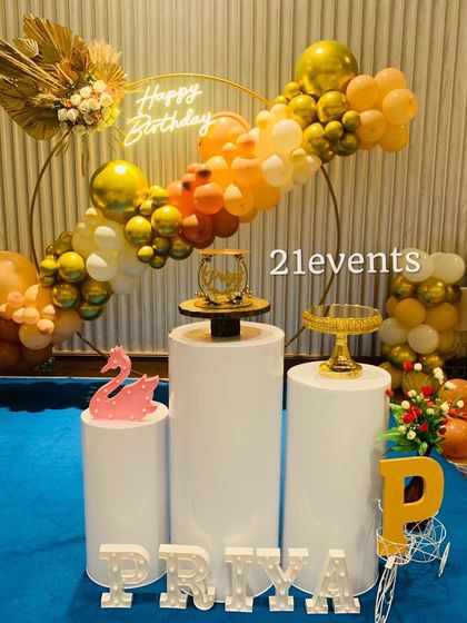 Another view of the boho-chic setup, showing the clean white pedestals and marquee letters.