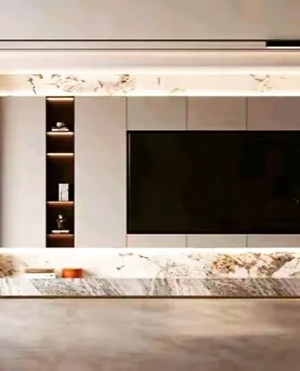 A luxurious media wall featuring a striking marble frame around the TV and console area. A recessed, internally lit niche provides elegant display space, adding to the high-end feel of the room.