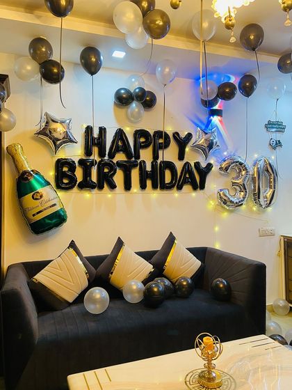 The fairy lights behind the 'Happy Birthday' banner add a warm glow to the decoration.