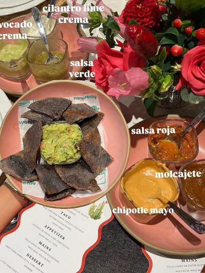 A spread of house-made salsas and dips for a Mexican-themed supper club, including salsa verde, salsa roja, and chipotle mayo with blue corn chips.