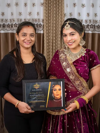 A student poses with her model after creating a stunning Rajasthani-inspired bridal look. This is a key part of building a diverse and impressive professional portfolio.